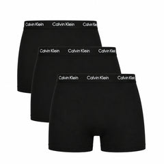 Three pairs of black Calvin Klein boxer briefs on a white background