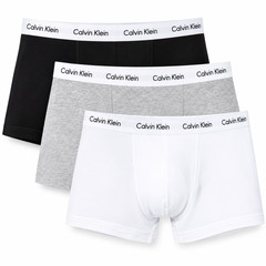 Three pairs of Calvin Klein men's boxer briefs in black, heather gray, and white, arranged in a diagonal stack on a plain white background.