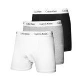 A pack of three Calvin Klein boxer briefs in black, white, and grey colors, displayed with the Calvin Klein logo on the waistband.