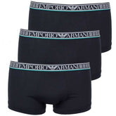 A set of three black Emporio Armani trunk boxer briefs with white and green branded waistbands.