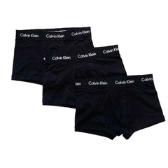 Three pairs of black Calvin Klein boxer briefs arranged in a staggered stack on a plain white background, with the brand name printed in white on the waistbands.