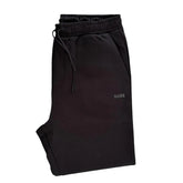 Black BOSS jogger sweatpants with an elastic waistband, black drawstring, and a small silver BOSS logo on the left thigh, shown against a plain white background.
