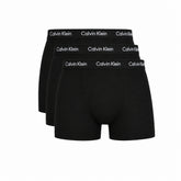 Three pairs of black Calvin Klein boxer briefs arranged in a fan shape against a white background.