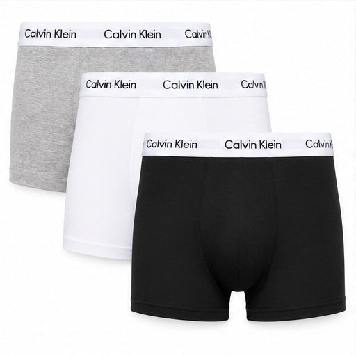 Three pairs of Calvin Klein boxer briefs arranged in a stack on a white background, showing the gray, white, and black options with the brand name printed on the waistbands.