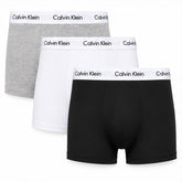 Three pairs of Calvin Klein boxer briefs arranged in a stack on a white background, showing the gray, white, and black options with the brand name printed on the waistbands.