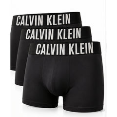 Three pairs of black Calvin Klein boxer briefs arranged in a staggered stack, each with a wide black waistband featuring the brand name 'CALVIN KLEIN' in bold white capital letters, set against a plain white background.