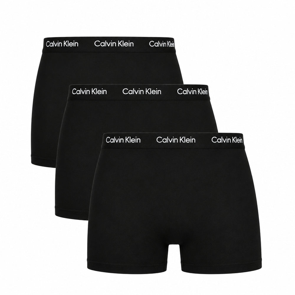 Three pairs of black Calvin Klein boxer briefs on a white background