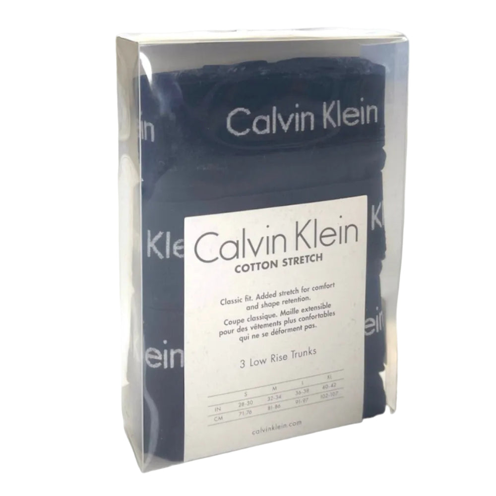 Calvin Klein cotton stretch low-rise trunks in a clear plastic package with a white paper label, showing the dark navy blue folded fabric inside.