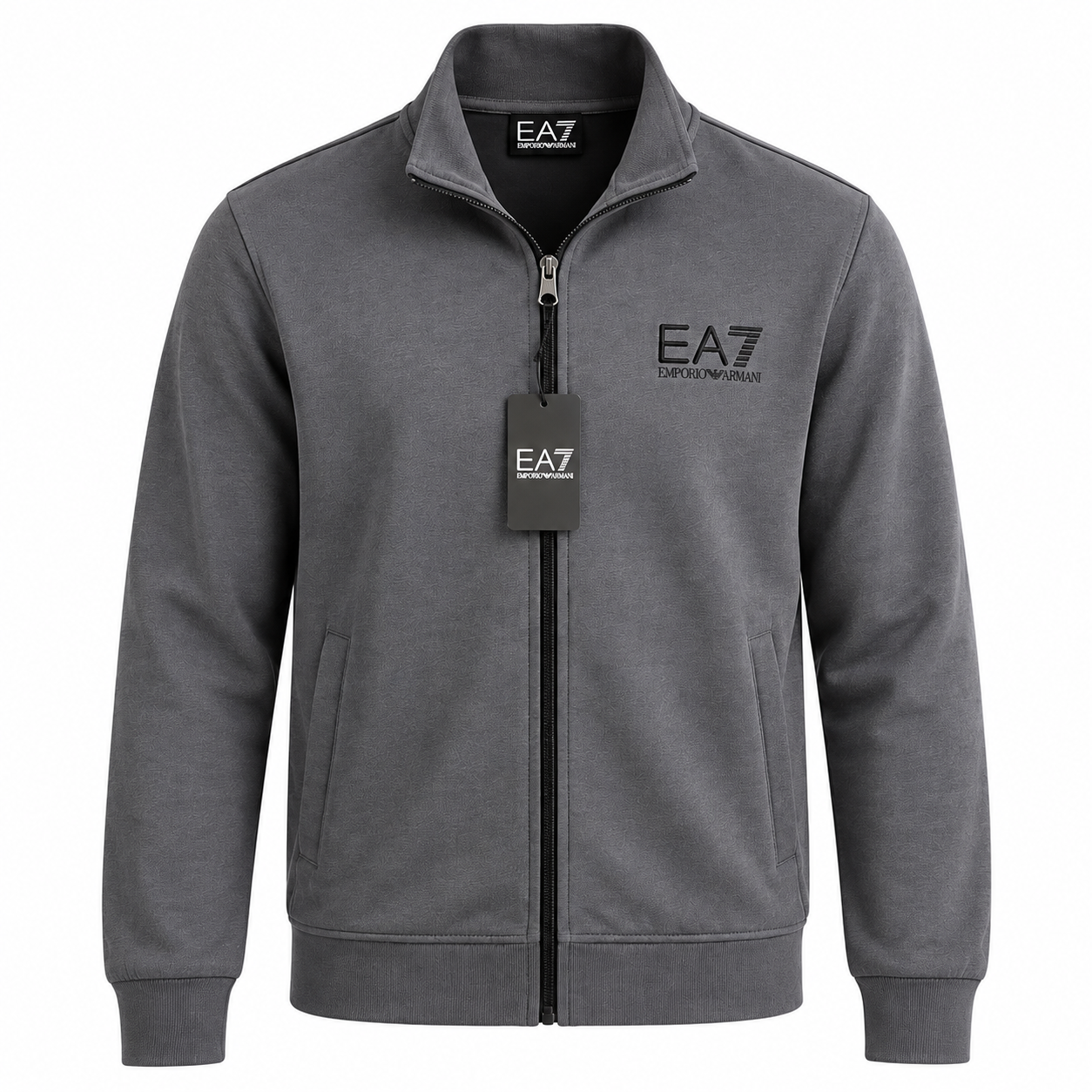 A dark gray zip-up jacket with a stand collar, featuring the 'EA7' logo on the left chest and a matching hangtag on the zipper, shown against a plain white background.