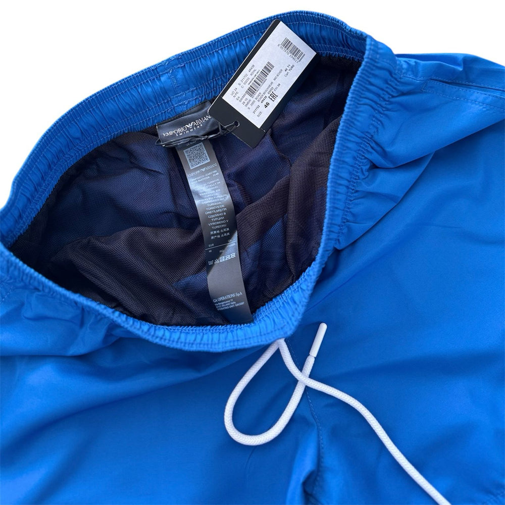 Blue jacket with a brand tag on a white background