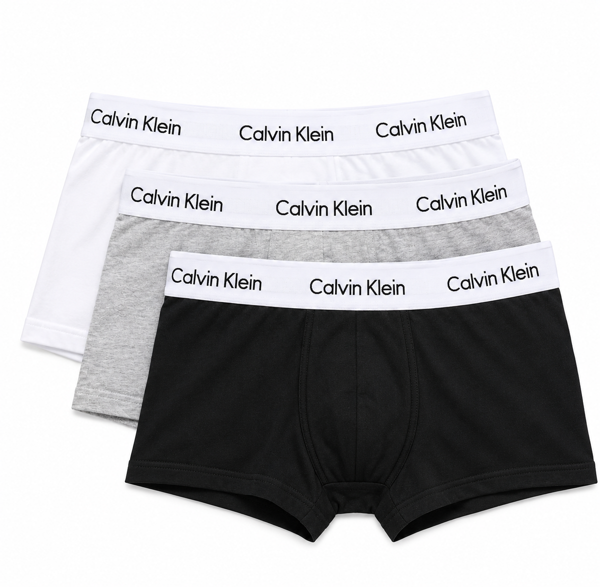 Three pairs of Calvin Klein boxer briefs stacked in a fan arrangement on a white background, featuring black, light gray, and white fabrics with white elastic waistbands printed with the Calvin Klein brand name.