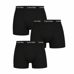 Three pairs of black Calvin Klein boxer briefs arranged in a stacked layout on a plain white background, with the brand name visible on the waistbands.