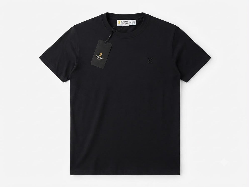 A black short-sleeve crewneck t-shirt by ZUNDOOZ London, featuring a small tonal embroidered logo on the left chest and a black hangtag attached to the collar, displayed on a clean white background.