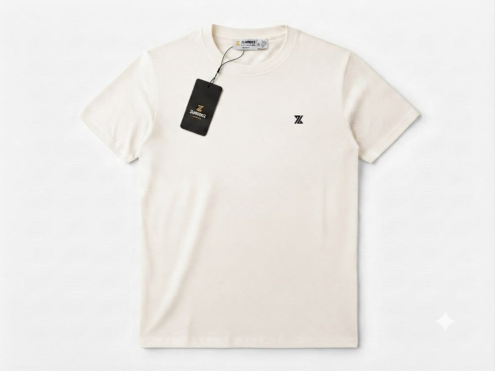 An off-white short-sleeve crewneck t-shirt with a small black embroidered logo on the left chest, featuring a black hangtag with gold lettering, displayed on a clean white background.