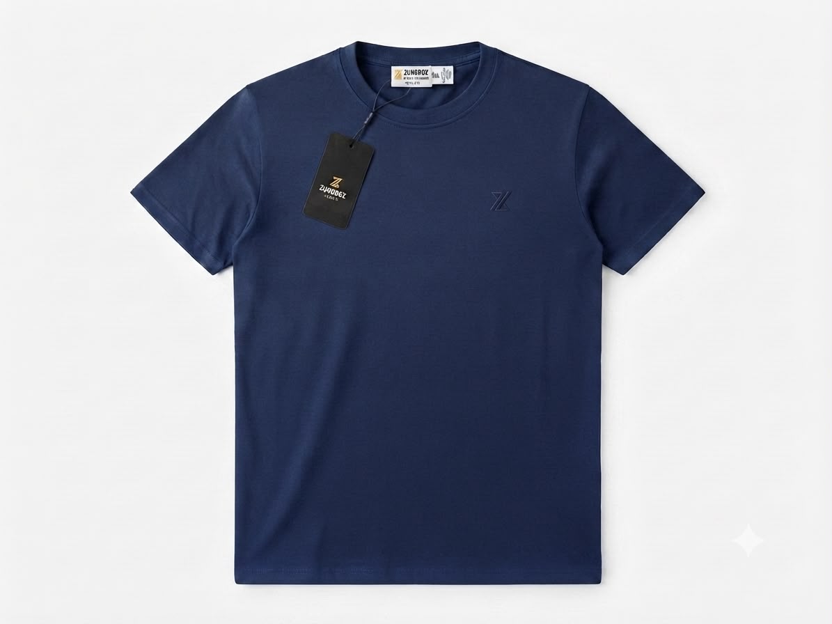A navy blue short-sleeve crewneck t-shirt by ZUNDOOZ London, shown flat against a light gray background with its black hangtag attached.