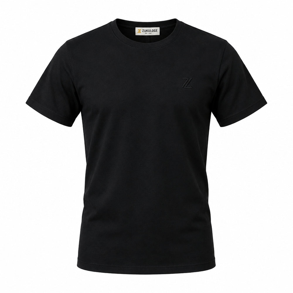 A black short-sleeve crewneck t-shirt by ZUNDOOZ London, featuring a small tonal embroidered logo on the left chest and a black hangtag attached to the collar, displayed on a clean white background.