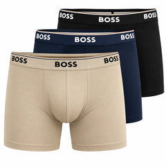 Three pairs of BOSS men's boxer briefs stacked diagonally on a white background, showing the beige, navy, and black colors with the BOSS logo on the waistbands.