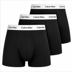 Three pairs of black Calvin Klein boxer briefs arranged in a staggered stack, showing the white waistband with the black Calvin Klein logo.