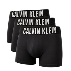 Three pairs of black Calvin Klein boxer briefs arranged in a staggered stack, each featuring a wide black waistband with 'CALVIN KLEIN' printed in bold white capital letters.