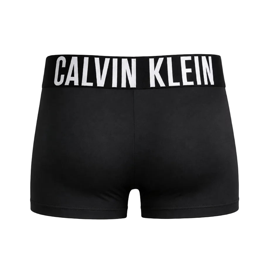 Black Calvin Klein boxer briefs shown on a mannequin from the back, featuring a wide black waistband with bold white CALVIN KLEIN branding.