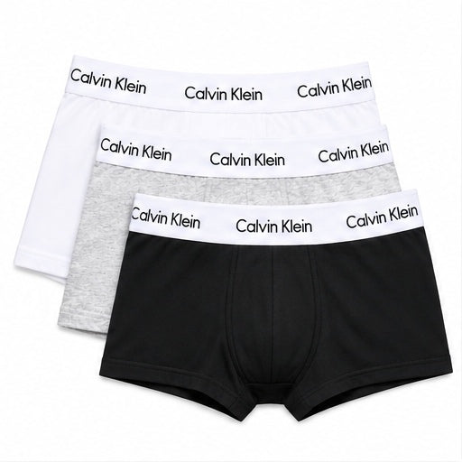 Three pairs of Calvin Klein men's boxer briefs stacked together on a white background, featuring black, light gray, and white fabrics with white waistbands printed with the Calvin Klein brand name.